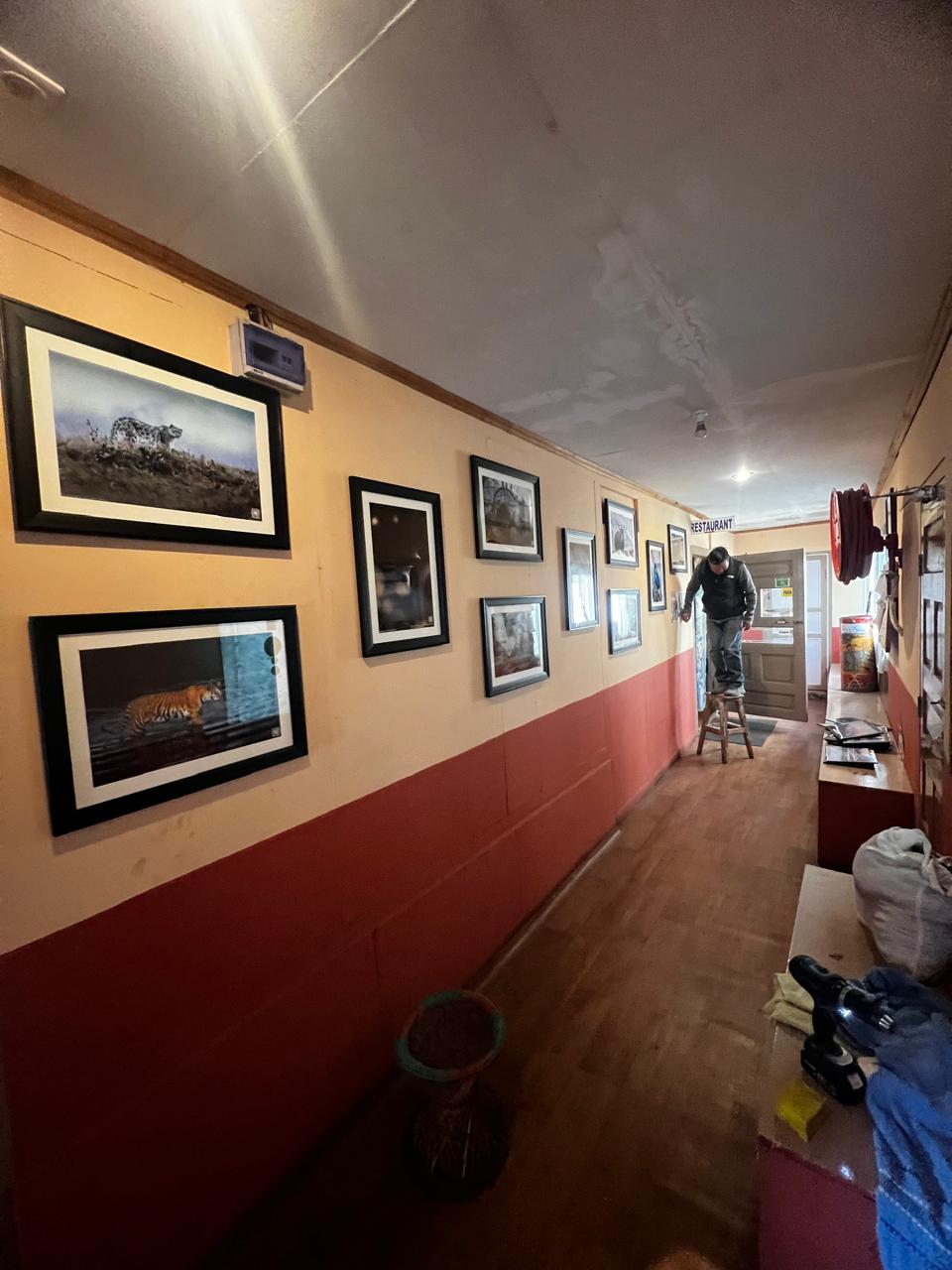 Framed mountain photography lining the lodge corridor