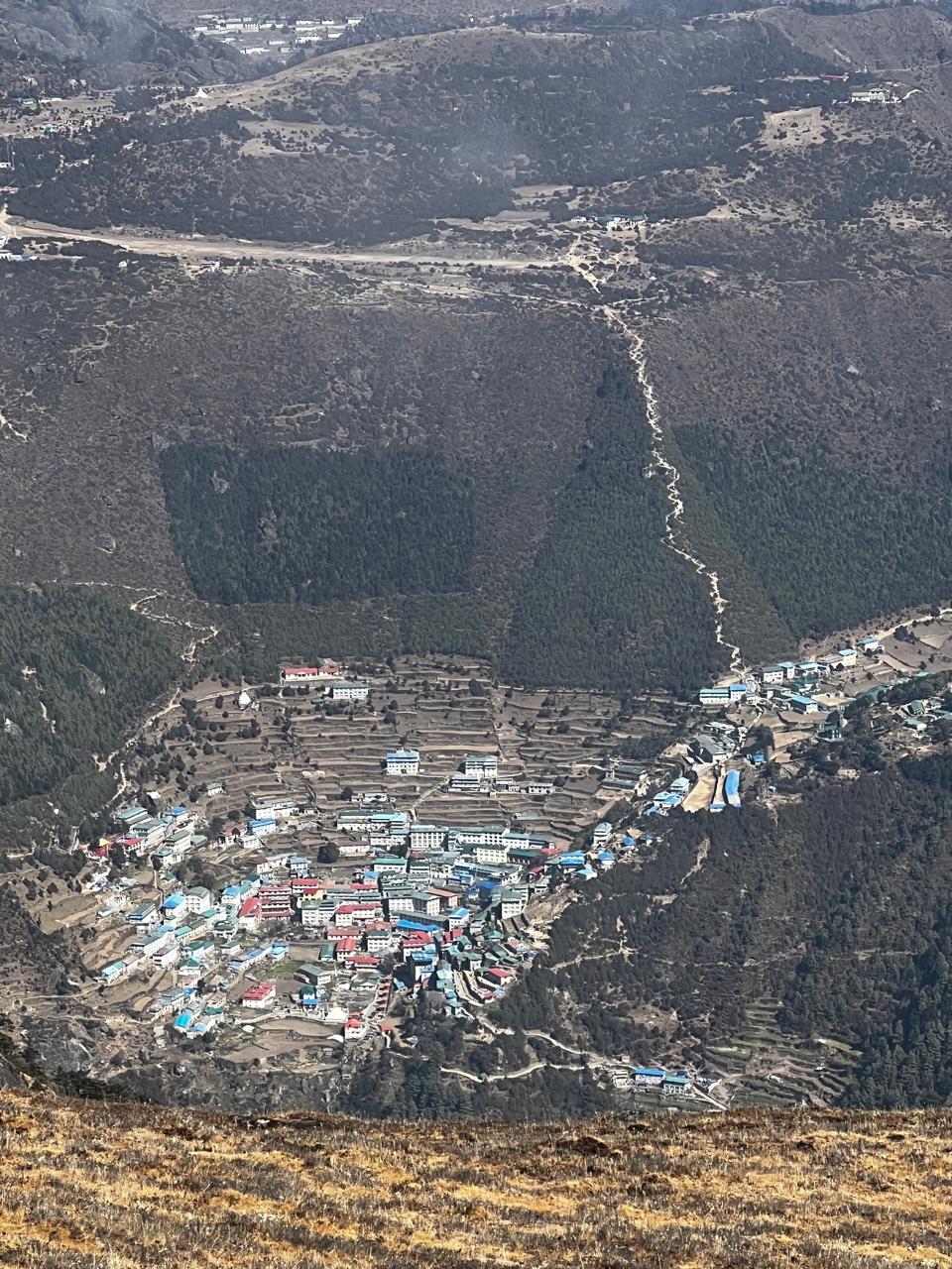 Namche Bazaar seen from the trail above, cupped in its mountain bowl